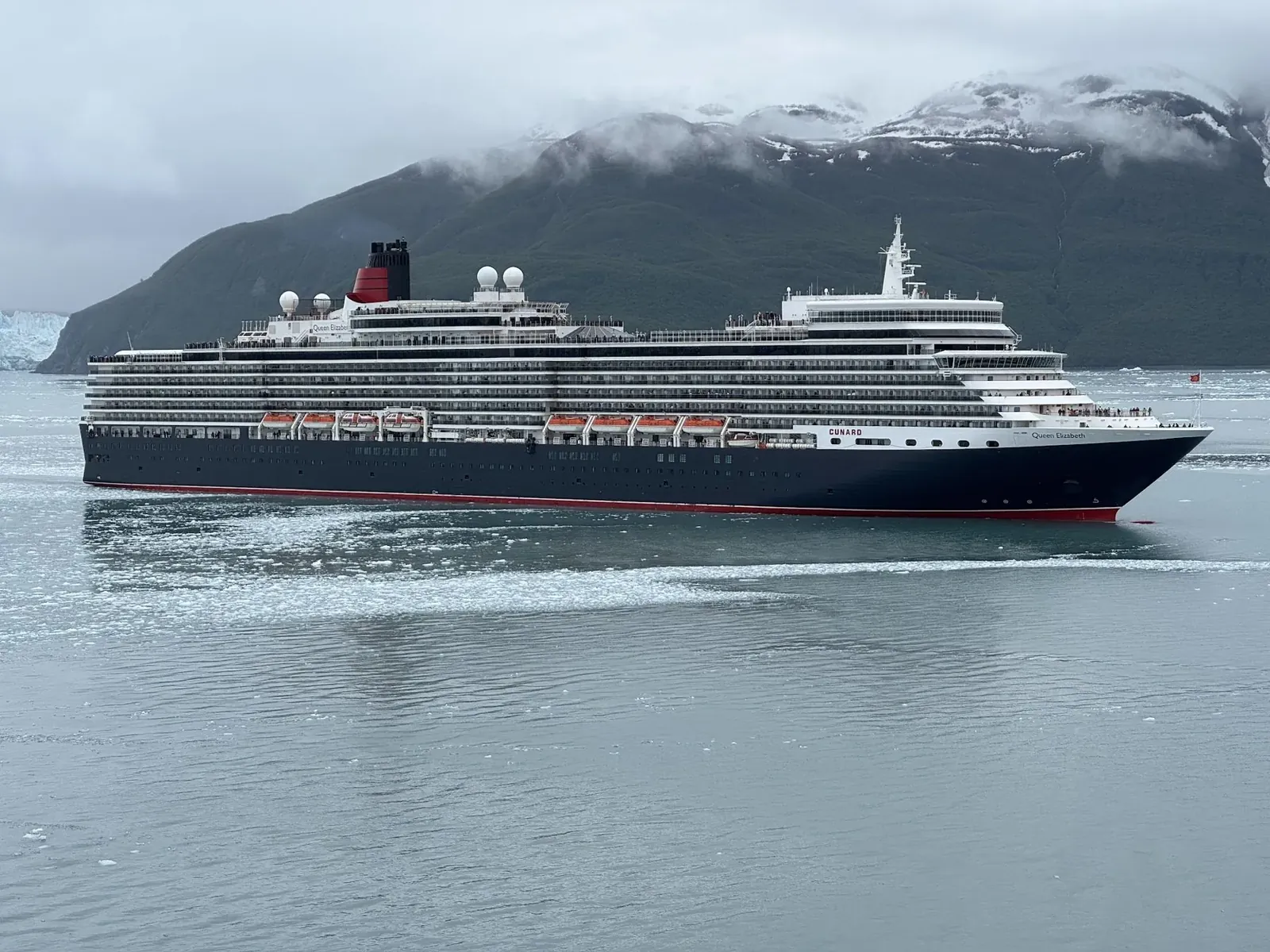 Luxury cruise ship in front of an Alaskan glacier