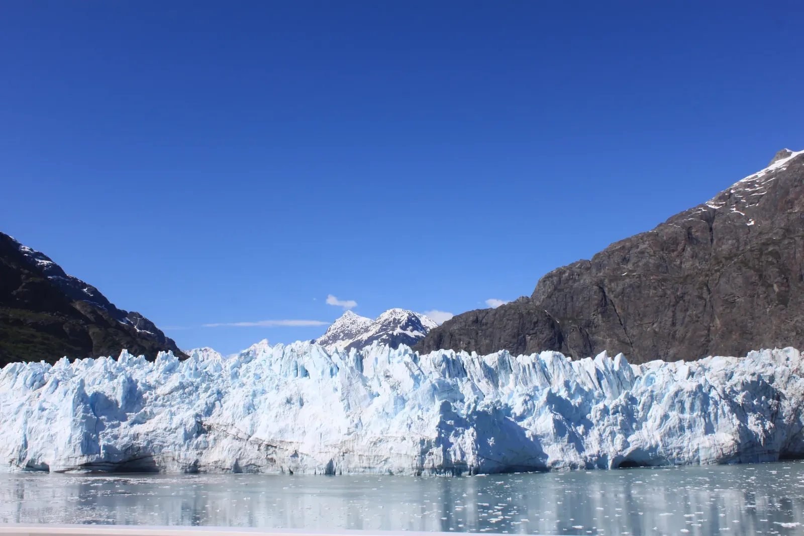 Margerie Glacier's blue ice face under a clear sky in Glacier Bay National Park