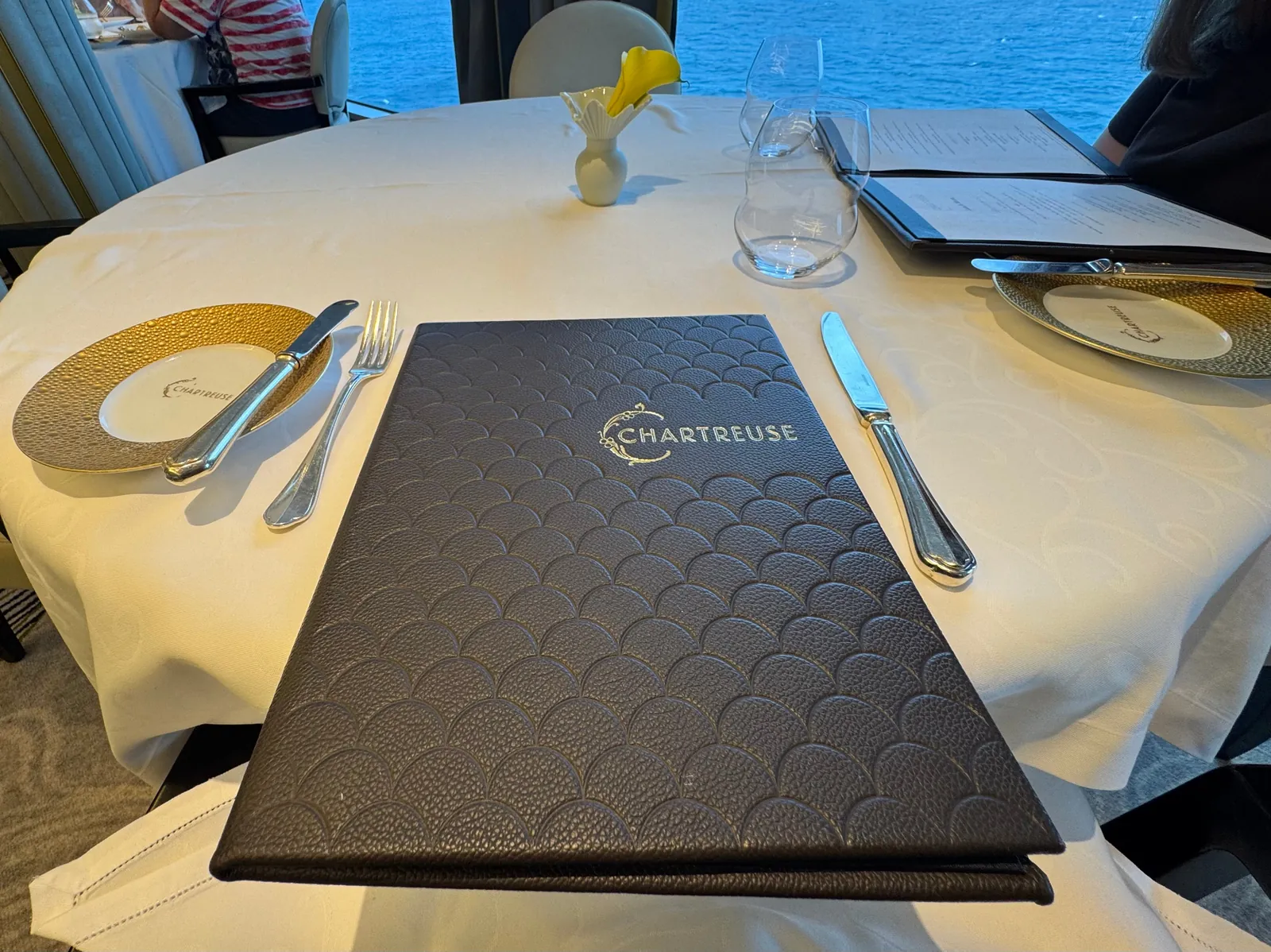 Chartreuse menu on a set table aboard a Regent Seven Seas ship
