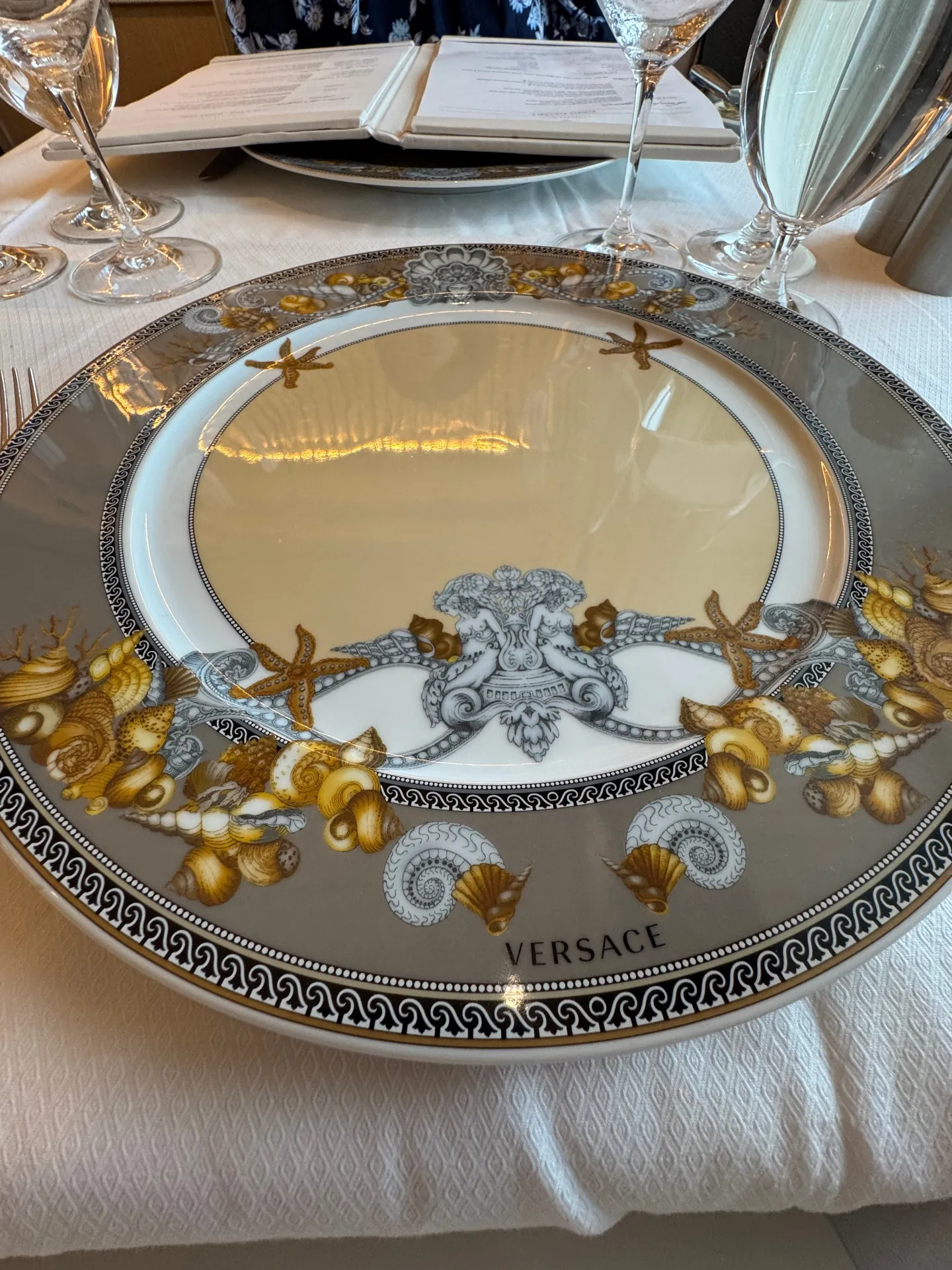 Versace charger plate set for dinner at Compass Rose aboard Regent Seven Seas