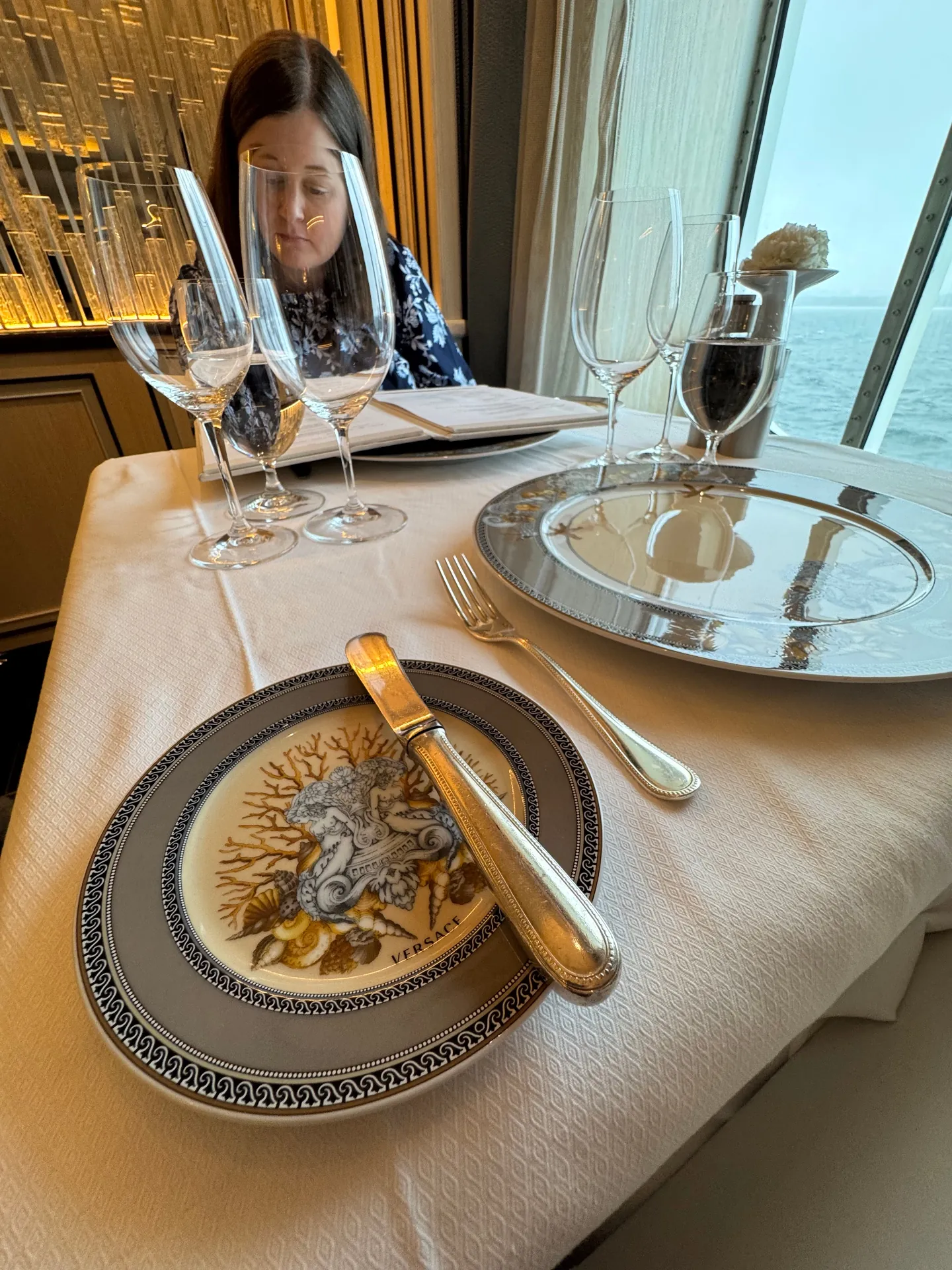 Compass Rose table setting with Versace china and glassware by the window