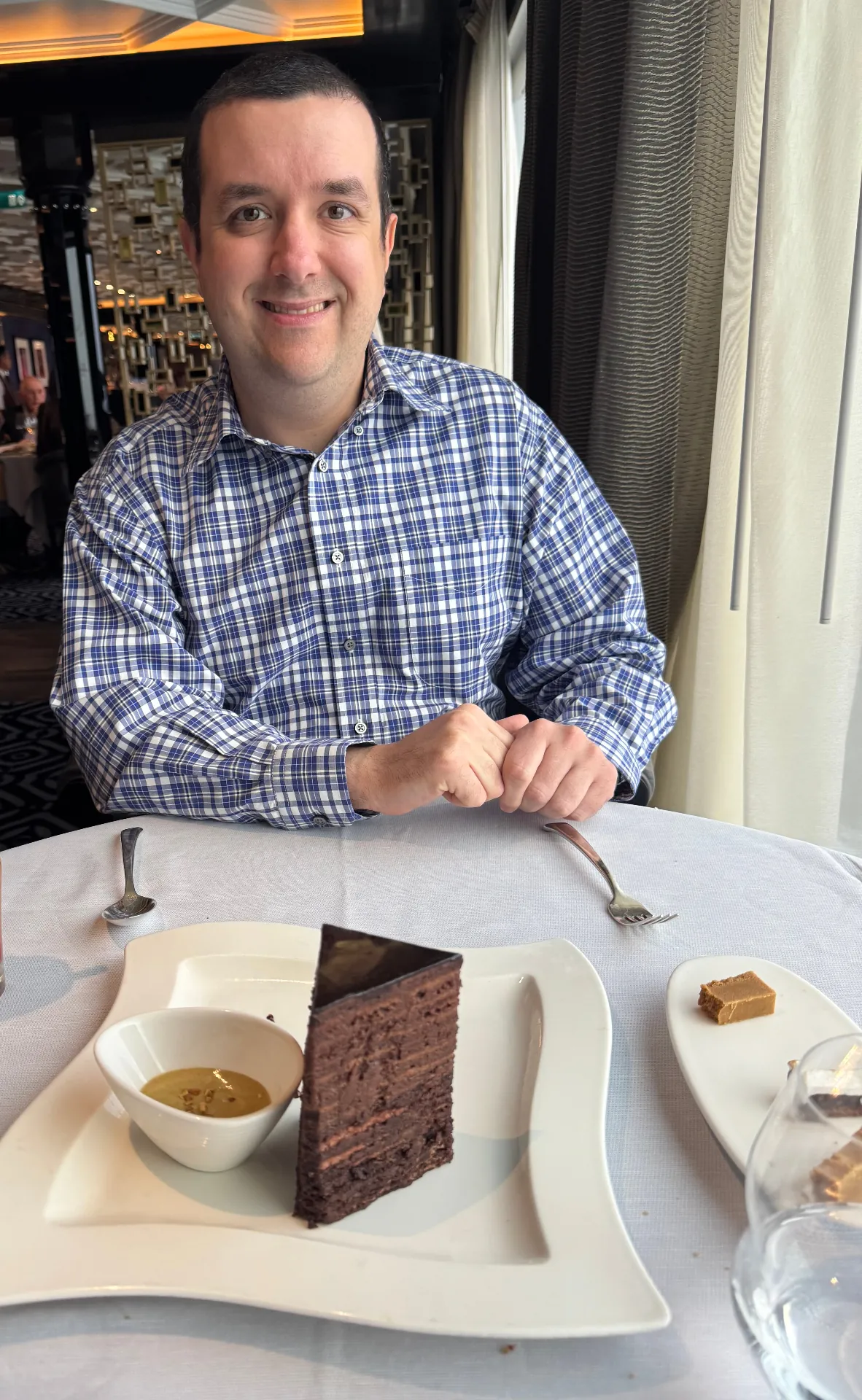 Ben at Prime 7 aboard Regent Seven Seas with the 14-layer chocolate cake