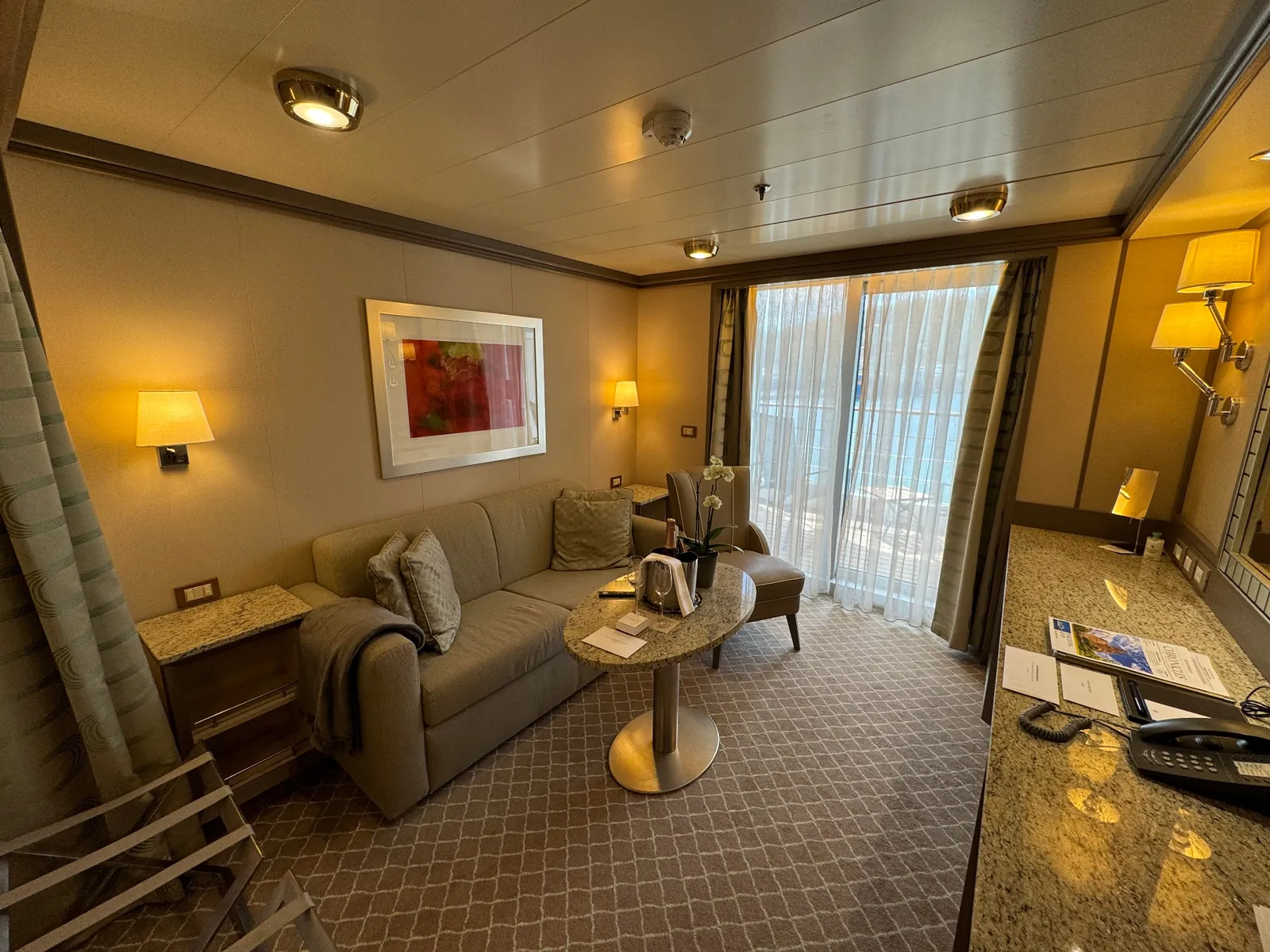 Sitting area of a Silversea suite with welcome champagne
