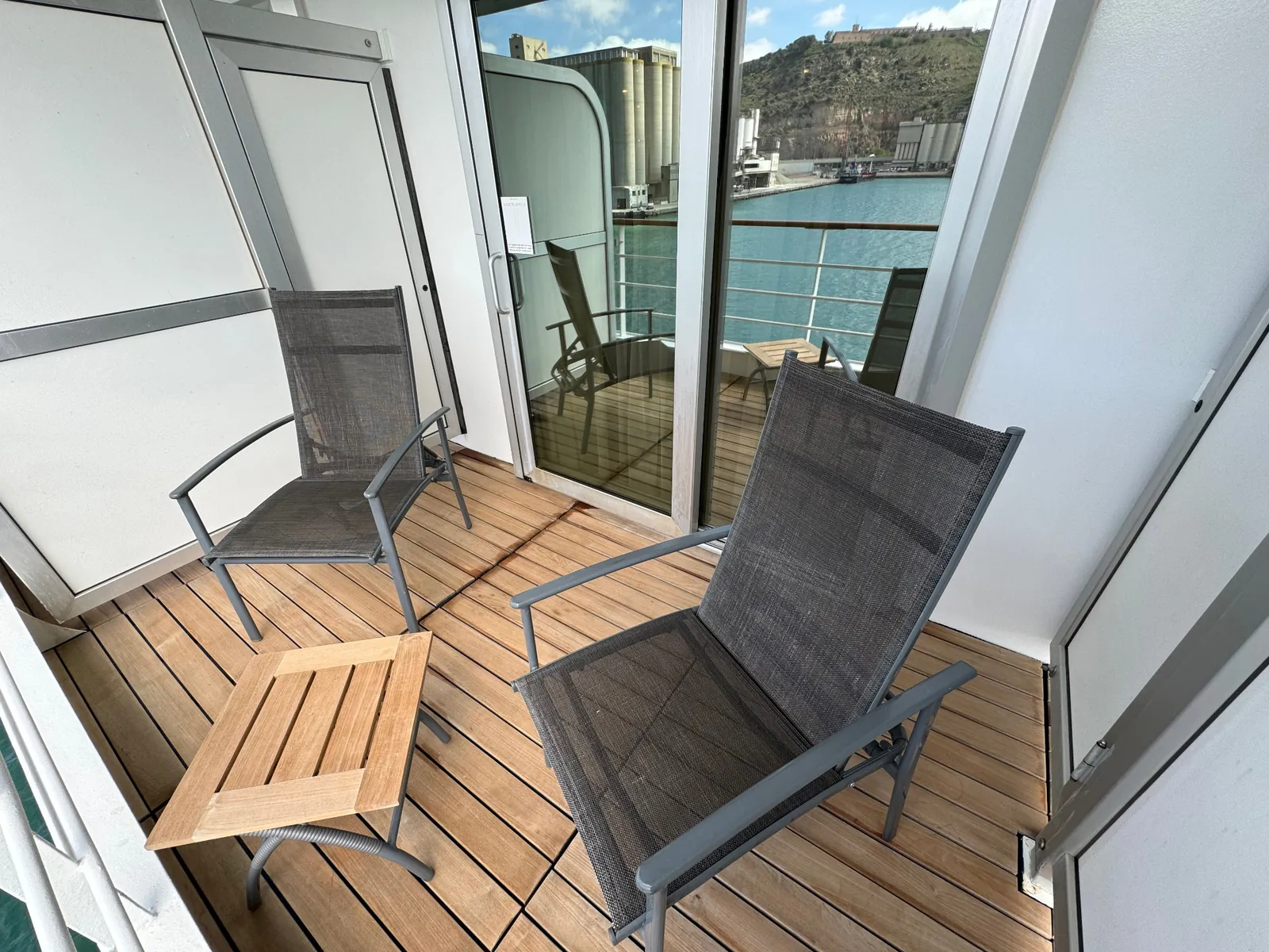 Private teak veranda on a Silversea suite overlooking the harbor