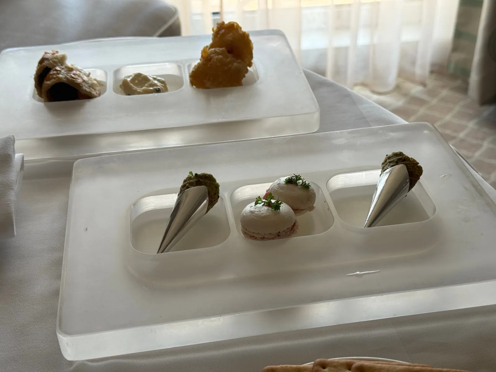Butler-served canapés on frosted acrylic trays